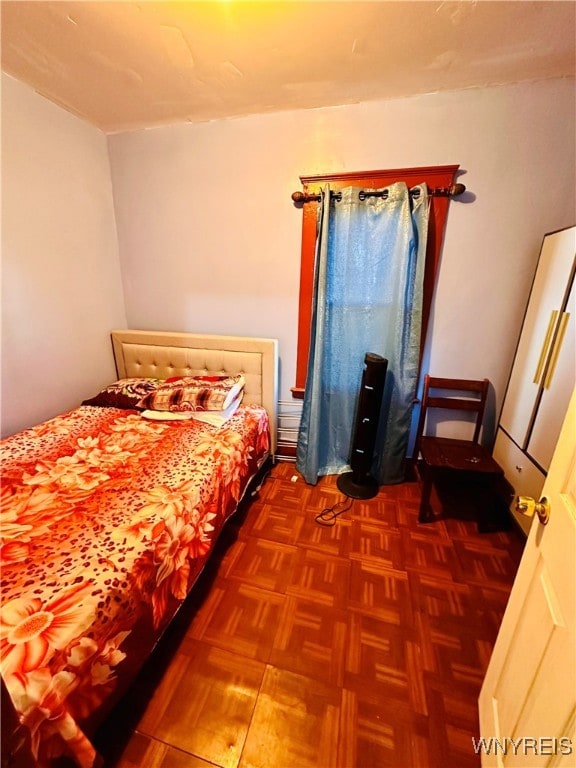 bedroom with dark parquet floors