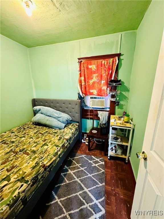 bedroom featuring dark wood-type flooring and cooling unit