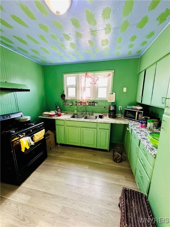 kitchen with sink, green cabinetry, light wood-type flooring, gas stove, and ventilation hood