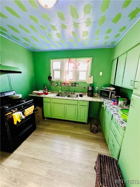 kitchen featuring black gas range, sink, and light hardwood / wood-style floors