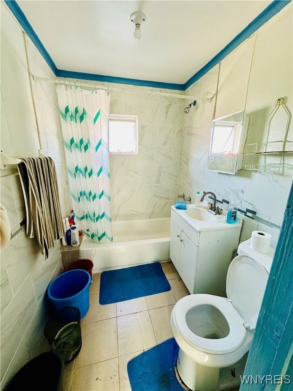 full bathroom featuring shower / bath combo with shower curtain, vanity, toilet, and tile walls