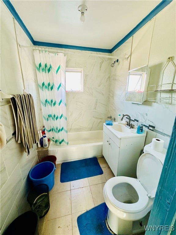 full bathroom with tile patterned floors, toilet, vanity, tile walls, and shower / bathtub combination with curtain