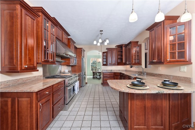 kitchen with kitchen peninsula, light tile patterned flooring, pendant lighting, a notable chandelier, and stainless steel appliances