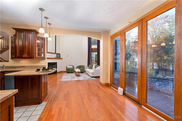 kitchen with light hardwood / wood-style flooring and decorative light fixtures