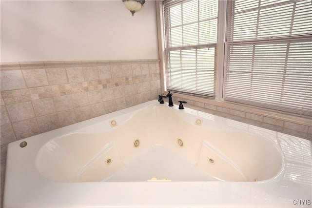 bathroom with a relaxing tiled tub