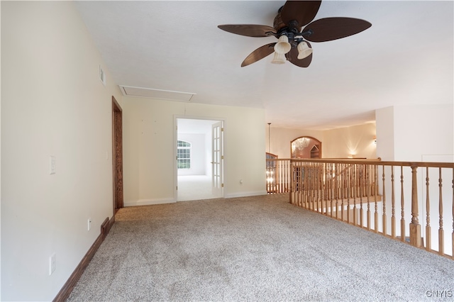 carpeted spare room featuring ceiling fan