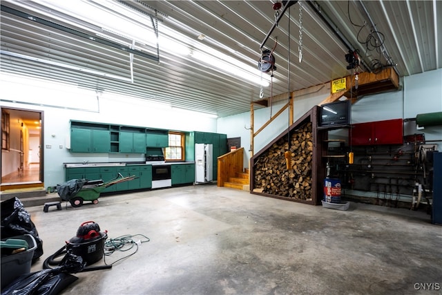 garage featuring white refrigerator with ice dispenser