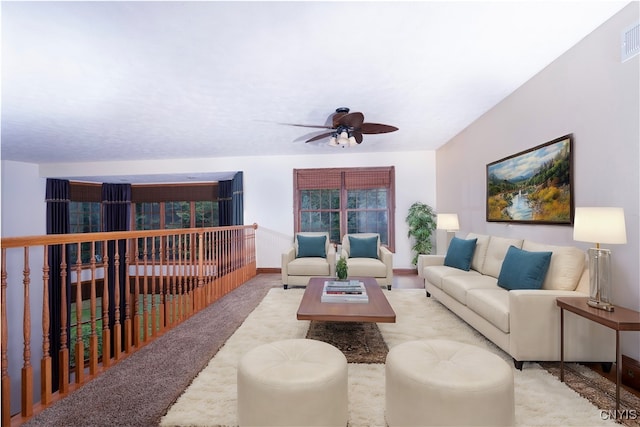 carpeted living room with ceiling fan