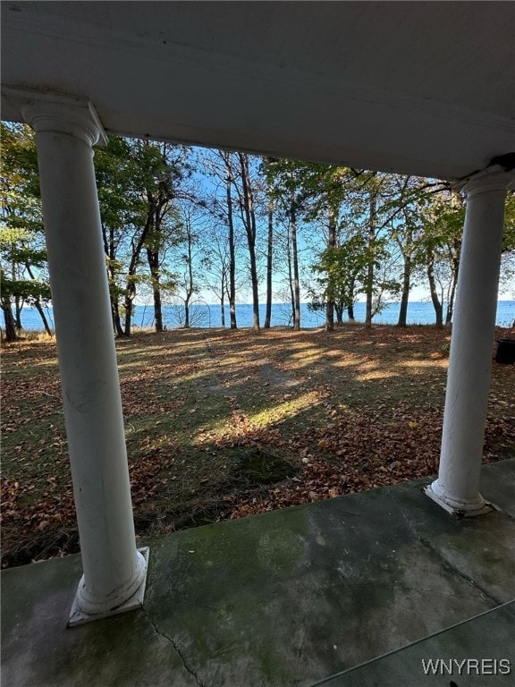 view of yard with a water view and a patio area