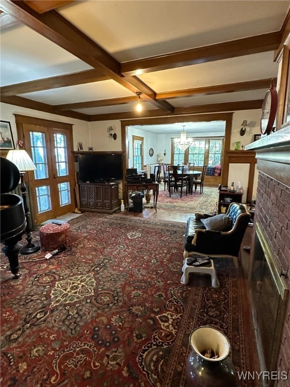 living room with a fireplace, a wealth of natural light, beamed ceiling, and carpet flooring