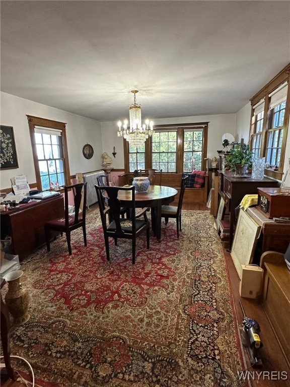 dining room featuring hardwood / wood-style floors and a notable chandelier