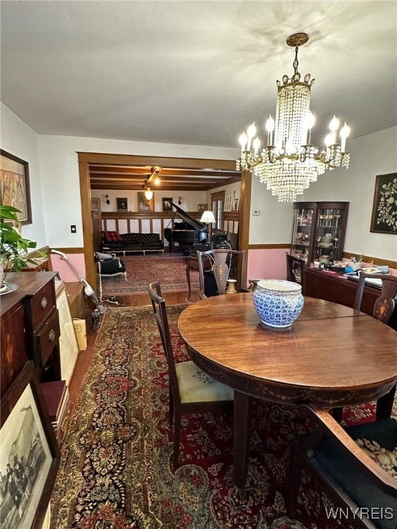 dining room with hardwood / wood-style flooring and a notable chandelier