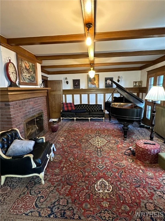 carpeted living room with a fireplace and beamed ceiling