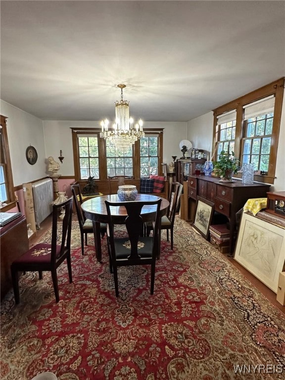 dining area with a healthy amount of sunlight and an inviting chandelier