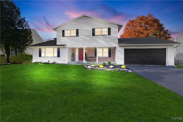 view of front facade with a garage and a yard