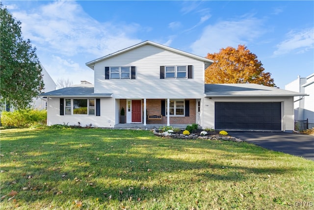 front of property featuring a front lawn and a garage