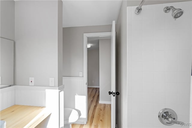 bathroom with hardwood / wood-style floors and tiled shower