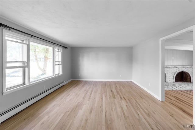 unfurnished living room featuring a fireplace, light hardwood / wood-style floors, and baseboard heating