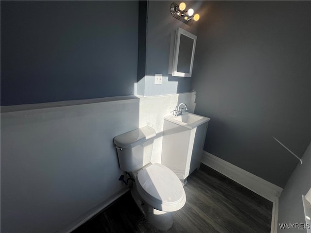 bathroom featuring sink, hardwood / wood-style floors, and toilet