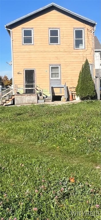 rear view of house with a yard