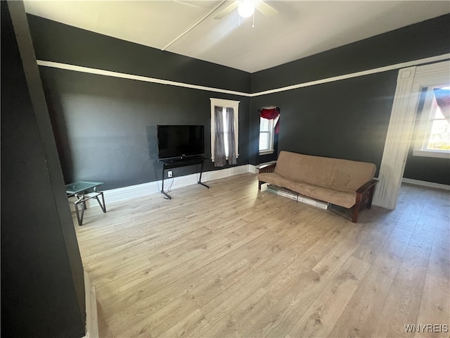 bedroom featuring multiple windows and light wood-type flooring