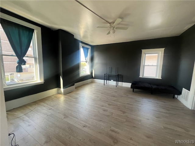 unfurnished room with light hardwood / wood-style flooring and ceiling fan