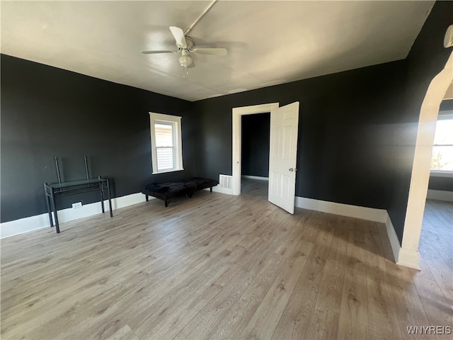 unfurnished room featuring light hardwood / wood-style floors, ceiling fan, and a wealth of natural light