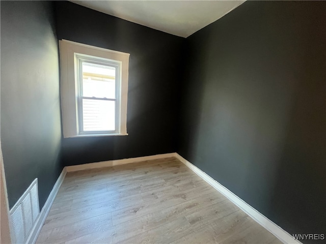 empty room with light hardwood / wood-style flooring