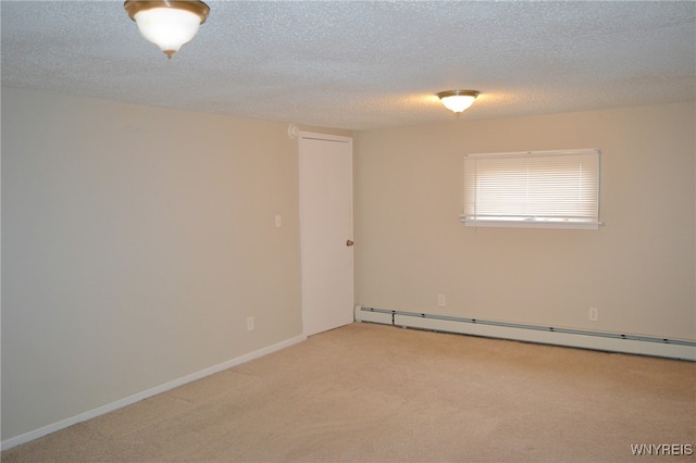 carpeted empty room featuring a textured ceiling and a baseboard heating unit