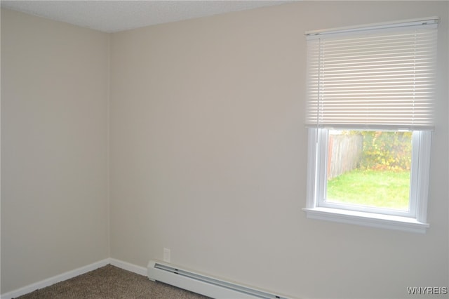 empty room with carpet and a baseboard heating unit