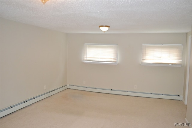 carpeted empty room featuring a textured ceiling and a baseboard radiator