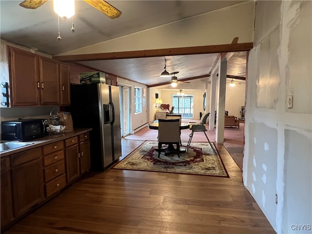 kitchen with baseboard heating, lofted ceiling, stainless steel fridge with ice dispenser, and hardwood / wood-style flooring