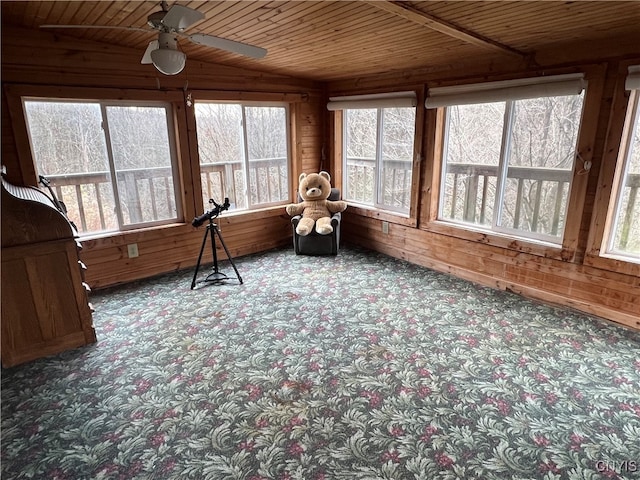 sunroom / solarium featuring wood ceiling, ceiling fan, and plenty of natural light