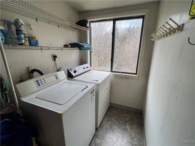 clothes washing area with washer and clothes dryer