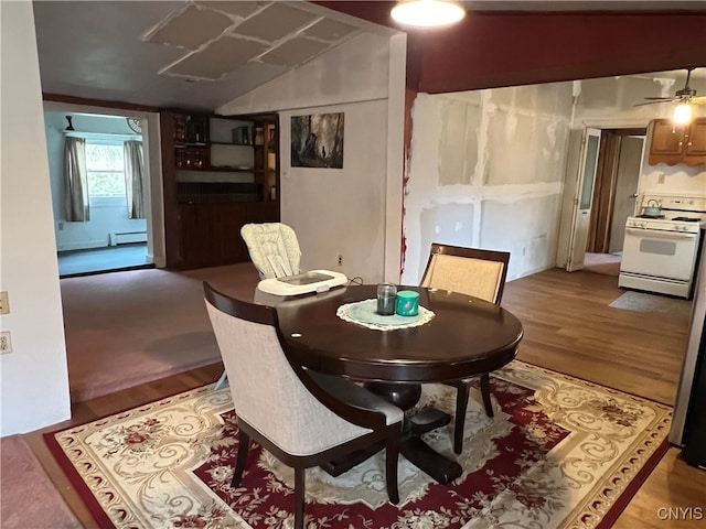 dining area with ceiling fan, lofted ceiling, baseboard heating, and hardwood / wood-style floors