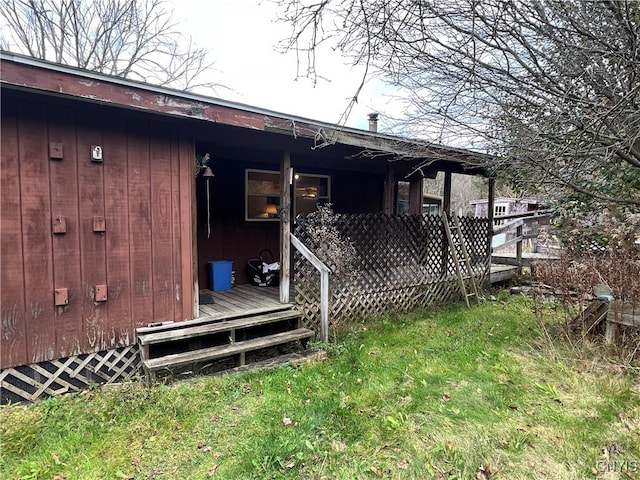 rear view of property featuring a wooden deck