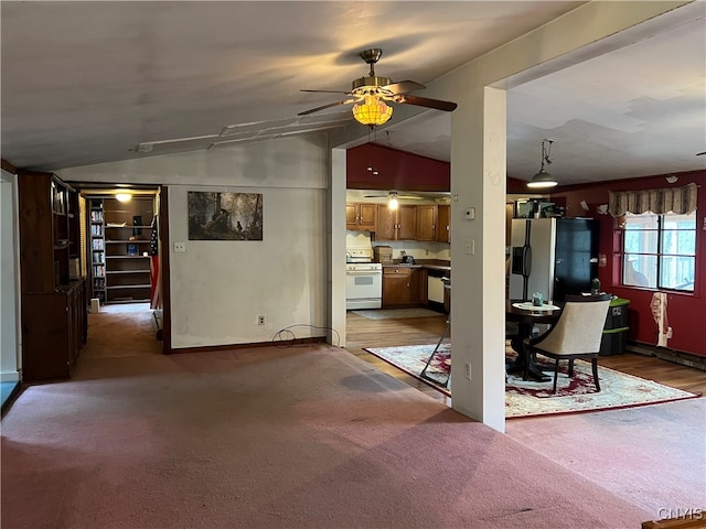 unfurnished living room with lofted ceiling, dark wood-type flooring, and ceiling fan