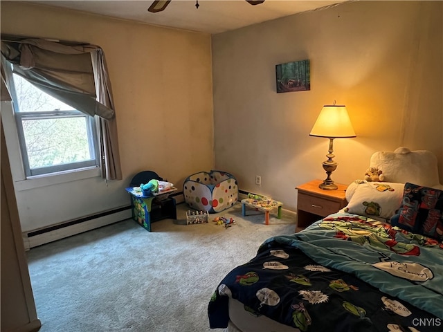 carpeted bedroom featuring a baseboard heating unit and ceiling fan