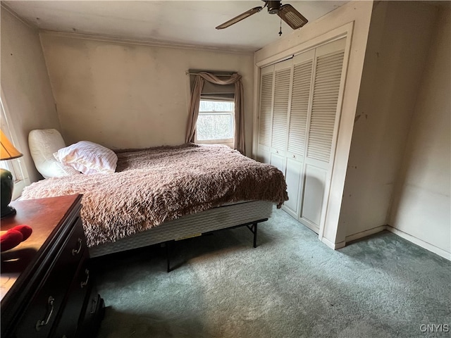 carpeted bedroom featuring a closet and ceiling fan