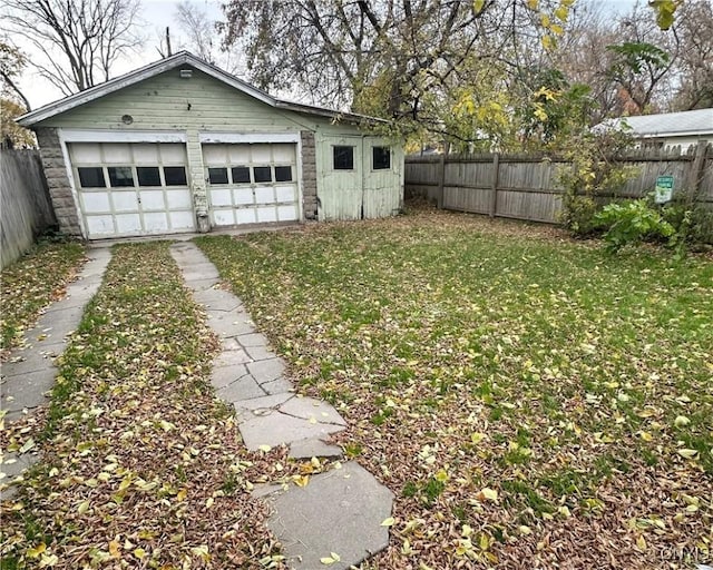 view of yard featuring an outbuilding and a garage