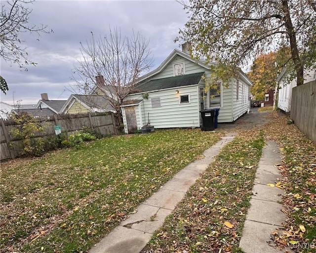 view of side of home featuring a lawn