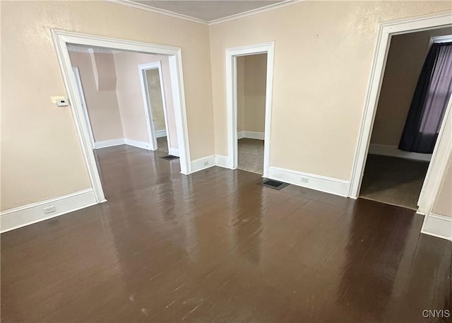 unfurnished room featuring dark wood-type flooring and ornamental molding