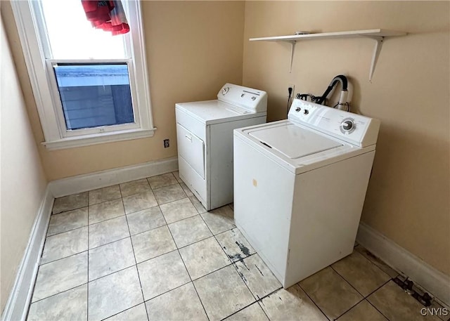 washroom featuring light tile patterned floors and washer and clothes dryer