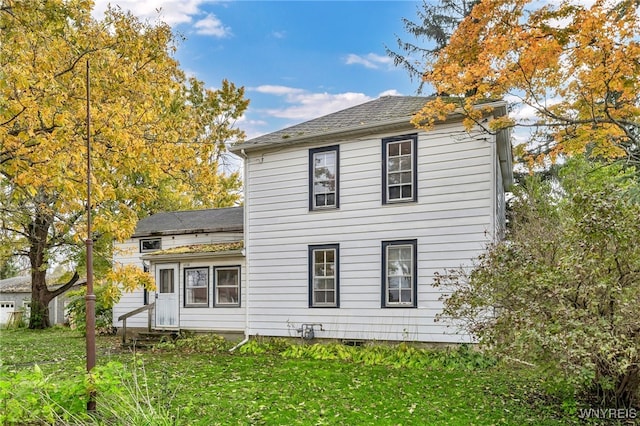 rear view of house with a yard