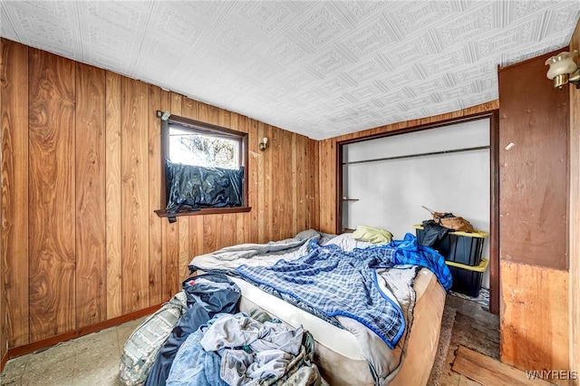 bedroom featuring wooden walls