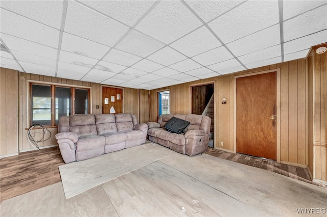 unfurnished living room with wood walls and wood-type flooring