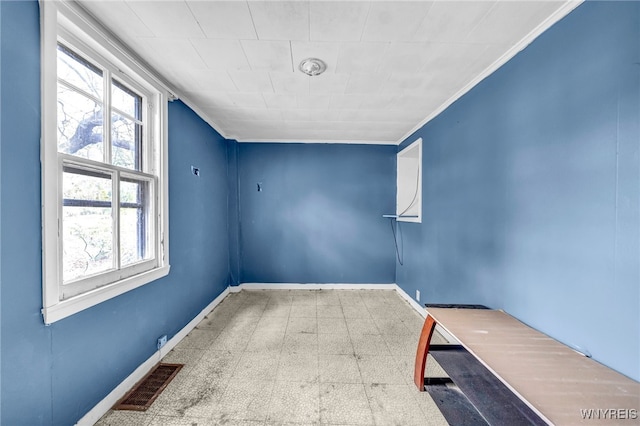 unfurnished room featuring crown molding