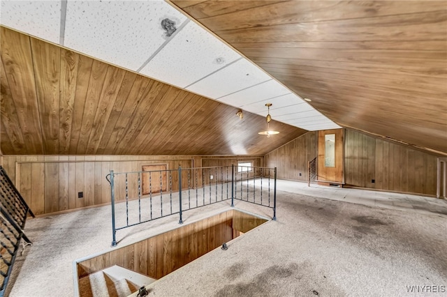 bonus room with carpet flooring, wood walls, wooden ceiling, and vaulted ceiling