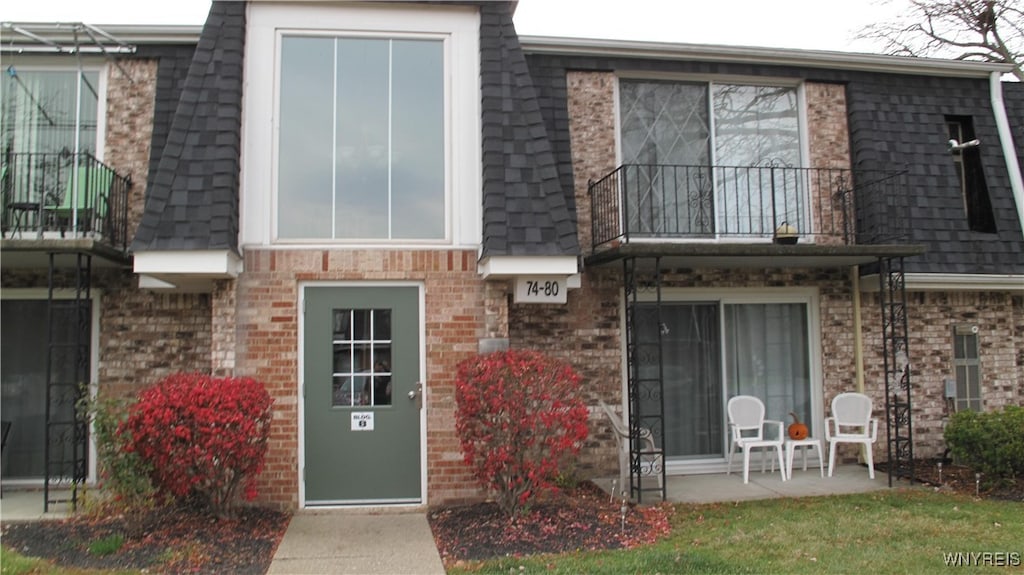 back of house with a balcony and a patio area