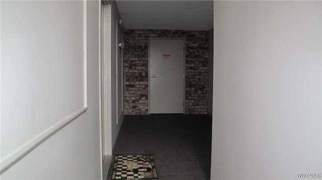 hallway with brick wall and carpet